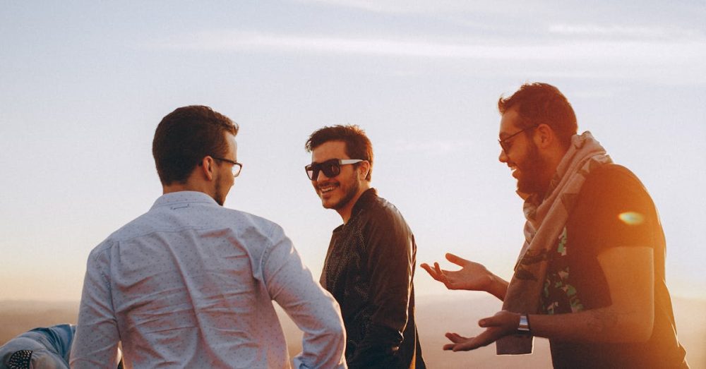 Group of male friends laughing together outdoors during sunset in Brazil.